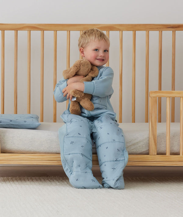 Toddler wearing a warm, ergoPouch Sleep Suit Bag 3.5 TOG Dragonflies