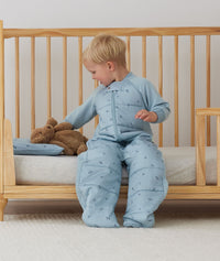 Toddler placing its teddy bear on an ergoPouch Organic Toddler Pillow Case Dragonflies