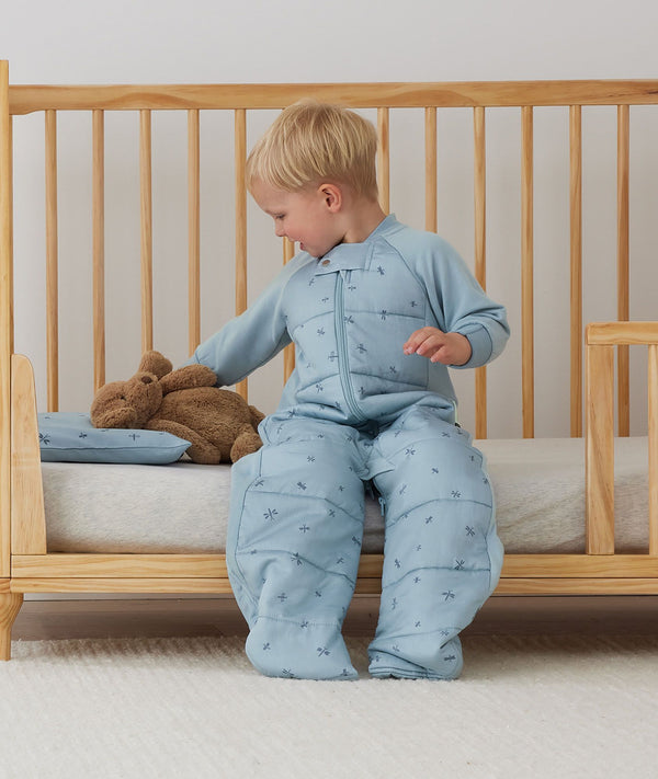 Toddler placing its teddy bear on an ergoPouch Organic Toddler Pillow Case Dragonflies