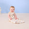 Baby smiling wearing ergoPouch Sleeping Bag 0.2 TOG in Bon Appetit