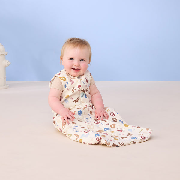 Baby smiling wearing ergoPouch Sleeping Bag 0.2 TOG in Bon Appetit