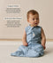 Infant wearing a blue sleeveless Sleeping Bag 1.0 TOG Dragonflies with text highlighting organic cotton and stretchy & bell-shaped design.