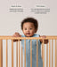 Infant wearing a sleeveless, light blue dragonfly-patterned sleeping bag stands in a wooden cot, holding onto the top rail with both hands. Above the baby, text features highlights for the product: Wash & Wear and TOG-Rated.