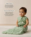 Infant wearing an ergoPouch Sleeping Bag 1.0 TOG Willow with text overlay highlighting organic cotton and stretchy & bell-shaped design.