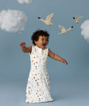 Infant in a cool ergoPouch Sleeping Bag 1.0 TOG Daydream with birds and clouds in the background, perfect for everyday