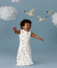 Infant in a cool ergoPouch Sleeping Bag 1.0 TOG Daydream with birds and clouds in the background, perfect for everyday