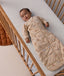 Sleeping baby in a cot wearing a printed long-sleeve Sleeping Bag 3.5 TOG Melody