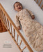 Baby lying in a cot wearing a printed long-sleeve Sleeping Bag 3.5 TOG, with text highlighting its slim-fit design for easy transition from swaddling.