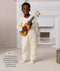 Preschooler standing and holding a ukulele, wearing a cream patterned slim-fit Sleep Onesie, with text explaining its design for toddlers and preschoolers.