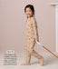 Preschooler walking while pulling a wooden toy, wearing a slim-fit beige patterned Sleep Onesie, with text describing its design for toddlers and preschoolers.