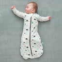 Baby wearing a Cocoon Swaddle Bag 1.0 TOG Clouds, with arms out