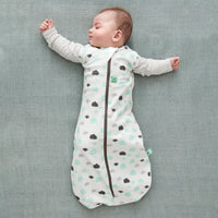 Baby wearing a Cocoon Swaddle Bag 1.0 TOG Clouds, with arms out