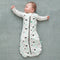 Baby wearing a Cocoon Swaddle Bag 1.0 TOG Clouds, with arms out