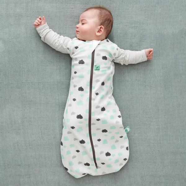 Baby wearing a Cocoon Swaddle Bag 1.0 TOG Clouds, with arms out