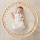 Baby wearing an ergoPouch Cocoon Swaddle Bag 1.0 TOG Fawn, with arms out