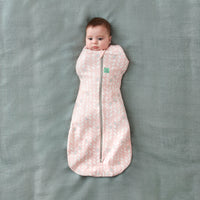 Baby wearing a Cocoon Swaddle Bag 1.0 TOG Spring Leaves