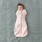 Baby wearing a Cocoon Swaddle Bag 1.0 TOG Spring Leaves