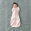 Baby wearing a Cocoon Swaddle Bag 1.0 TOG Spring Leaves