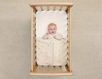 Baby is secured and safe with the form-fitted ergoPouch Tuck Sheet.