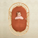 Baby lying under ergoPouch HugMe Blanket 0.2 & 1.0 TOG in Rust 