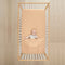Baby lying in cot wearing ergoPouch HugMe Blanket 0.2 & 1.0 TOG in Wheat 