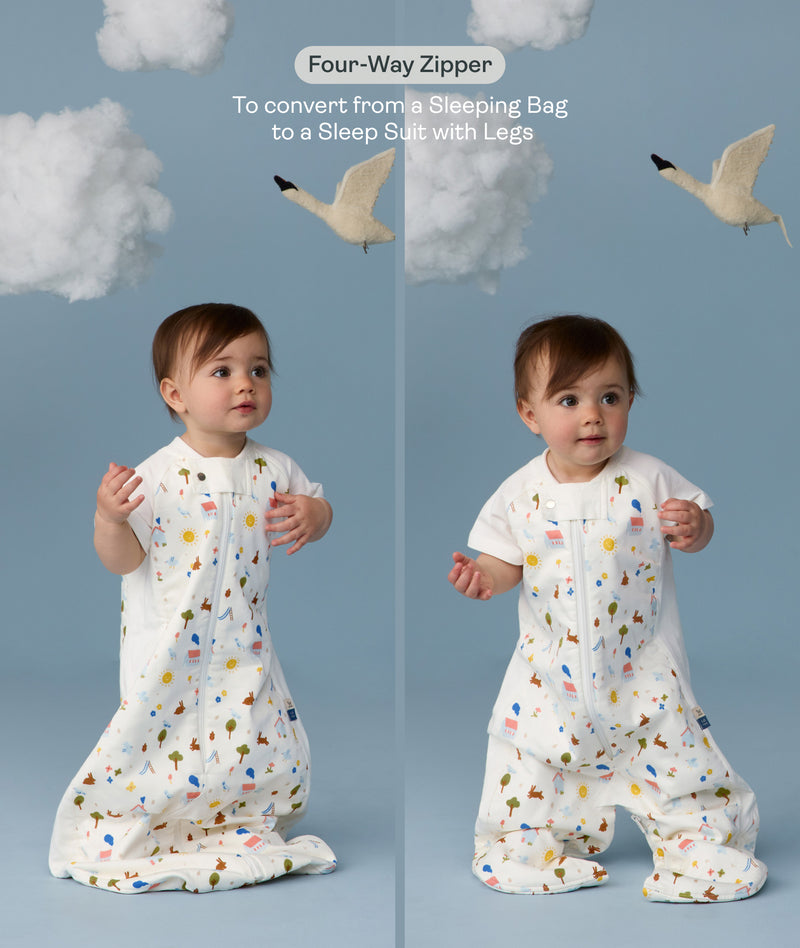 Two children wearing an ergoPouch Sleep Suit Bag 1.0 TOG Daydream, a sleeping bag that converts to a sleep suit with legs by a four-way zipper feature. 