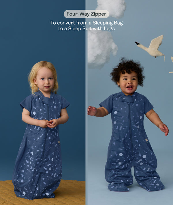 Two children wearing an ergoPouch Sleep Suit Bag 1.0 TOG Starbeam, a sleeping bag that converts to a sleep suit with legs by a four-way zipper feature. 