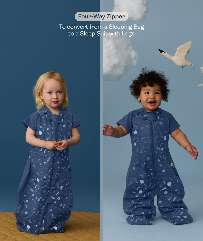 Two children wearing an ergoPouch Sleep Suit Bag 1.0 TOG Starbeam, a sleeping bag that converts to a sleep suit with legs by a four-way zipper feature. 