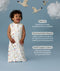 Infant wearing a ergoPouch Sleeping Bag 1.0 TOG Daydream with text about its features on a blue background with swans and clouds.