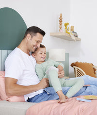 Preschooler and dad reading ergoPouch Hello, Sleep! Bedtime Affirmations for Kids