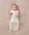 Newborn wearing an ergoPouch Cocoon Swaddle Bag 1.0 TOG Oatmeal Marle with arms out