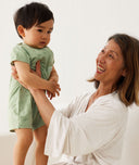 Mum wearing a an Mum wearing a an 2000, holding a child, holding a child