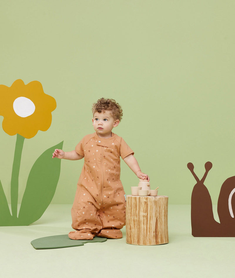 Baby wearing an ergoPouch Sleep Suit Bag 1.0 TOG Honey Bees