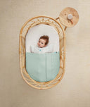 ergoPouch Drift Away White Noise Machine Taupe on table near cot