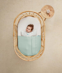 ergoPouch Drift Away White Noise Machine Taupe on table near cot