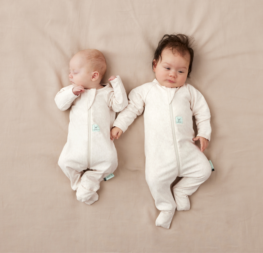 a newborn and an infant baby wearing 1.0 TOG layer